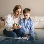 An RBT and a kid with autism sitting on a couch during ABA therapy