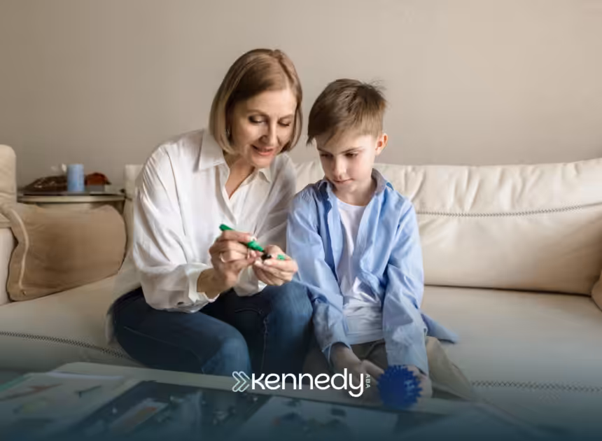 An RBT and a kid with autism sitting on a couch during ABA therapy
