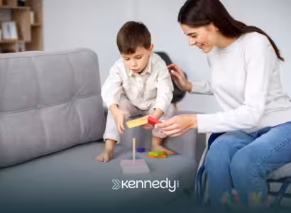 A kid with autism and an ABA therapist during ABA therapy