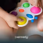 A kid holding a colorful widget toy