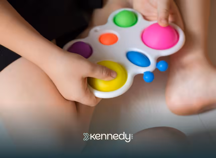 A kid holding a colorful widget toy