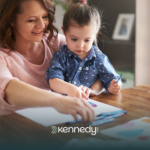 An RBT and a girl with autism looking at insurance papers