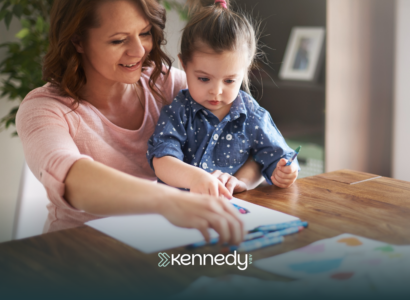 An RBT and a girl with autism looking at insurance papers