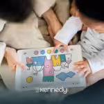 An RBT and a kid with autism looking at a coloring book