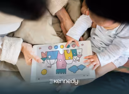 An RBT and a kid with autism looking at a coloring book