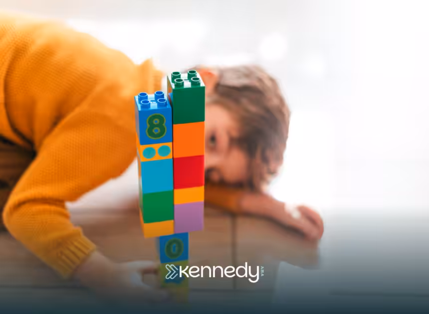 A tower of colorful toy blocks being looked at by a kid with autism