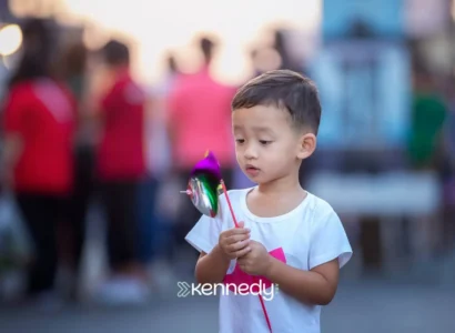 young-boy-holding-colorful-pinwheel-outdoors-in-public-space