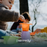 A kid with autism on a weekend activity, playing sand outdoors