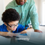 A kid with autism doing an activity while an adult is supervising
