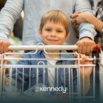 A kid with autism pushing a shopping cart with his parents