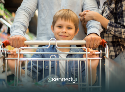A kid with autism pushing a shopping cart with his parents