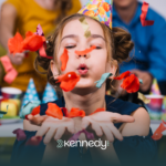 A kid with autism blowing confetti in an autism-friendly event in Hampton, VA