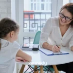 child-meeting-with-aba-therapist-at-table