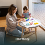 A kid with autism and an RBT in a living room during ABA therapy