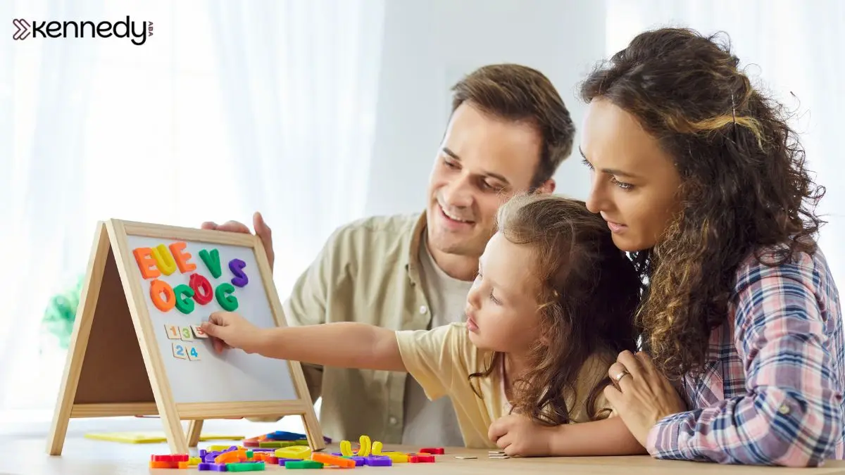 parents-and-child-playing-with-alphabet-board