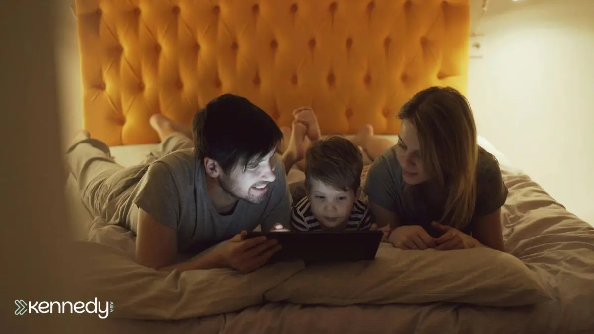 parents-and-child-using-digital-device-at-night