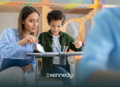 A kid with autism and his ABA therapist during school-based ABA therapy
