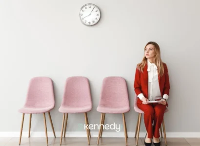 woman-waiting-in-clinic-reception-area-with-tablet