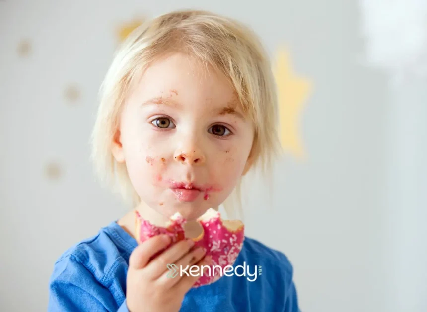 young-girl-eating-pink-frosted-donut