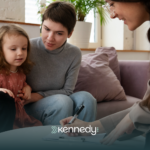 A mother with her child with autism talking to an ABA therapist