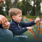 A kid with autism holding a kite outdoors