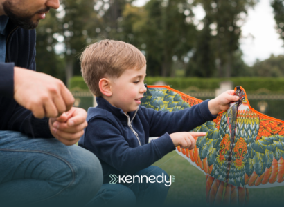 A kid with autism holding a kite outdoors