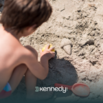 A kid with autism playing with beach sand