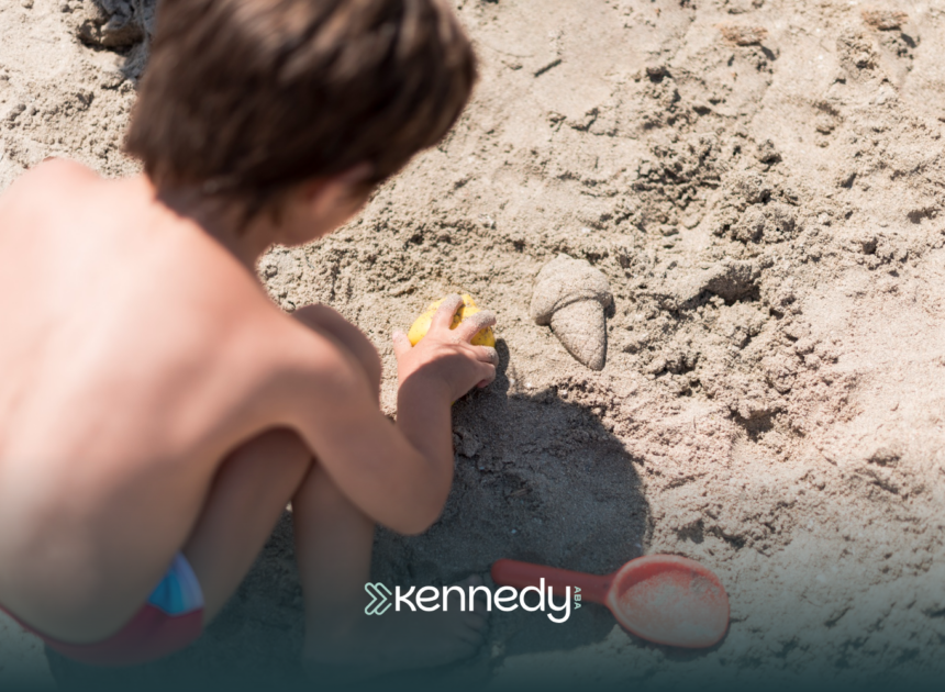 A kid with autism playing with beach sand