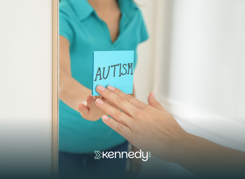A kid sticking a sticky note with the word "autism" on a mirror