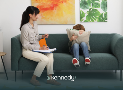 A BCBA talking to a child with autism on a couch