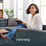 A BCBA holding a clipboard, sitting on a couch
