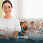 A BCBA holding a clipboard standing in front of kids during ABA therapy
