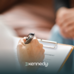 An ABA therapist writing on a clipboard
