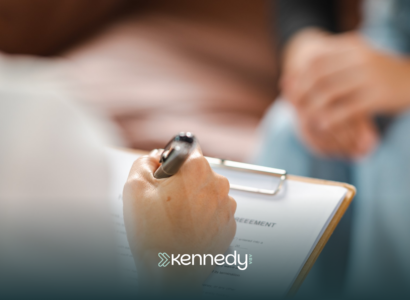 An ABA therapist writing on a clipboard