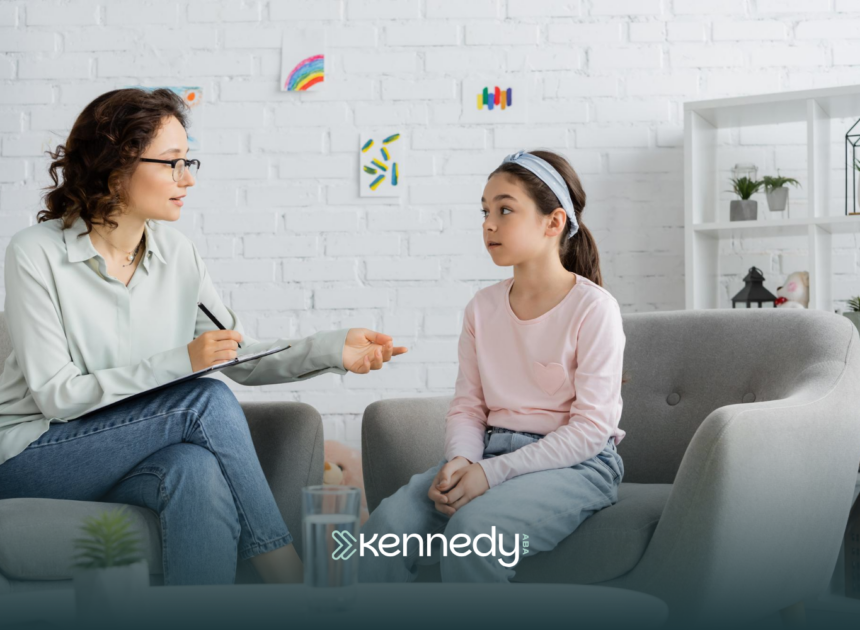 A kid with autism and an ABA therapist talking during ABA therapy