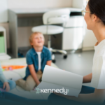 An ABA therapist talking to students in a classroom
