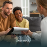 An insurance provider staff talking to a parent with his son about ABA therapy