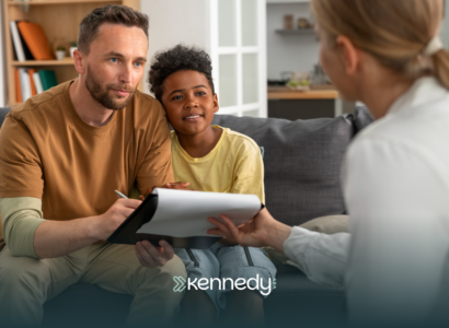 An insurance provider staff talking to a parent with his son about ABA therapy