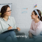 A BCBA talking to a kid during ABA therapy