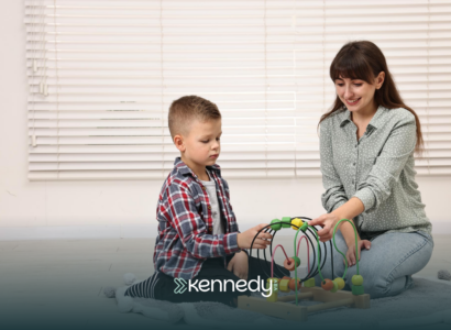 A kid with autism and an ABA therapist talking during ABA therapy