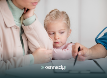 A BCBA explaining the autism evaluation to a parent with her kid watching