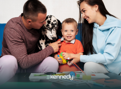 A family in Charlotte, NC, with a kid with autism and their family dog, sitting on a couch