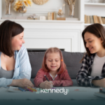 A mother, along with her kid with autism, talking to an insurance agent regarding prior authorization for ABA therapy