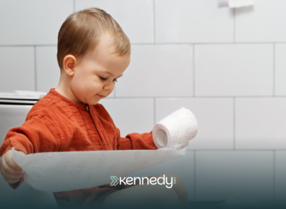 A kid with autism holding a roll of tissue, during toilet training