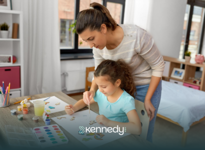 A therapist teaching a kid how to draw during ABA therapy