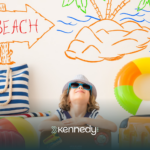 A kid ready for summer, with summer goals behind him written on a wall