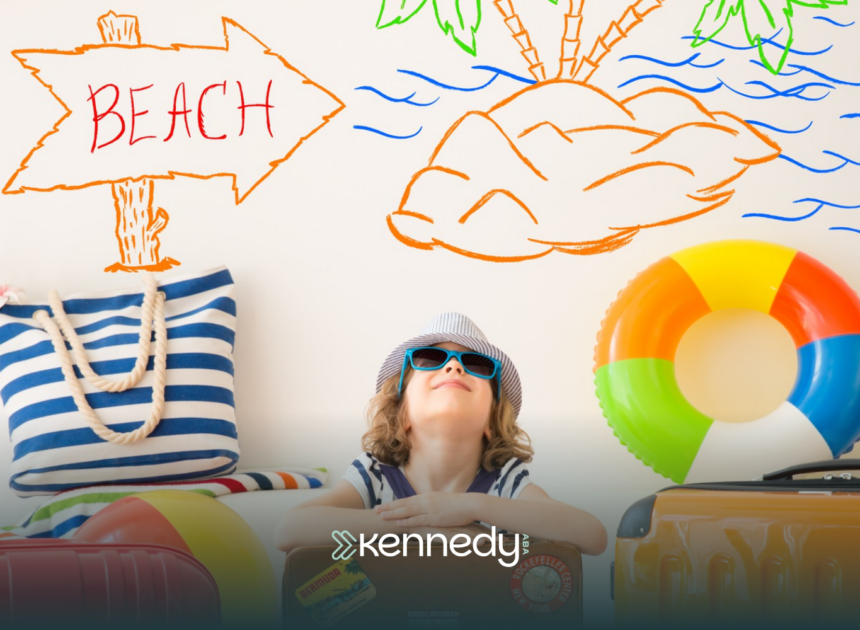 A kid ready for summer, with summer goals behind him written on a wall