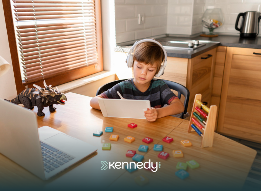 A kid with autism using a mobile tablet while at a table