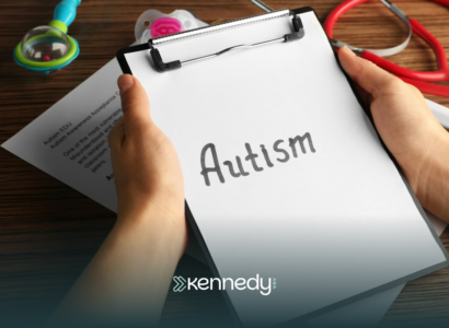 A clipboard with the word 'autism' being held by a person