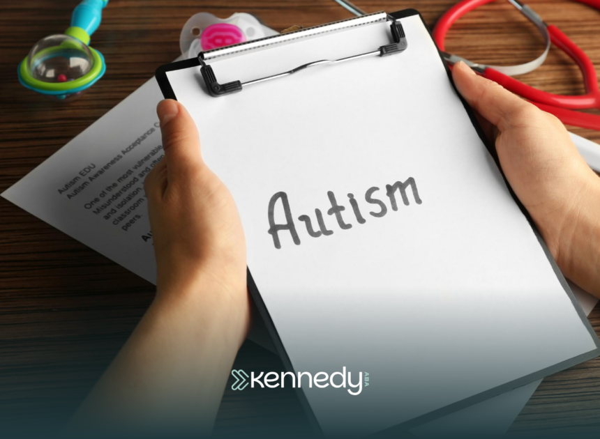 A clipboard with the word 'autism' being held by a person